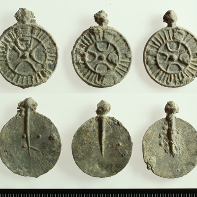 Three lead Christian amulets and mould, <a href ="https://www.sydvestjyskemuseer.dk/en/"target="_blank">Southwest Jutland Museums, SJM 3</a>; c. 810 – c. 830; Ribe; EXH6: Southwest Jutland Museums, SJM 3