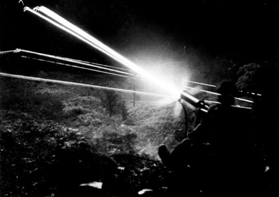 Photograph - Royal Marine commandos firing machine gun with tracers at night during training course; 2631