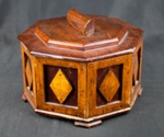 8 Sided Wooden Box with hinged lid and decorative diamond pattern. Approx 20 cm diameter. Made by German POW Albert Schimtz from POW camp near East Witton, Wensleydale.; 78127