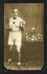 Photo of J.B McFeat in Egypt 1936, Boxing Champion, posing next to trophies. ; 76926