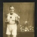Photo of J.B McFeat in Egypt 1936, Boxing Champion, posing next to trophies. ; 76926