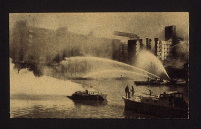 Press photograph - A.F.S. fire vessels fighting wharfside fires in East Ham - with original text; 6715