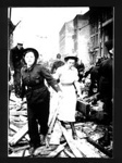 Photograph - A.R.P Warden and nurse searching for bomb damage victims; 1811