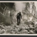 Official copyrighted war photograph- 11th October 1940- policeman inspecting damage near a bomb crater; 56531 Official copyrighted war photograph- 11th October 1940- policeman inspecting damage near a bomb crater; 56531