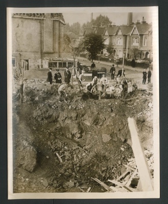 Official copyrighted war photograph- 15th August 1940- bomber wreckage amongst debris of damaged house; 56546