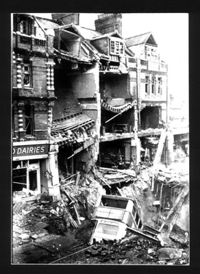 Photograph - bombed houses with double-decker bus in bomb crater; 1810 Photograph - bombed houses with double-decker bus in bomb crater; 1810