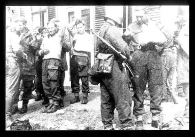 Photograph - taken at Arnhem dressing station - Eric Milner being searched by German soldier; 3507 Photograph - taken at Arnhem dressing station - Eric Milner being searched by German soldier; 3507