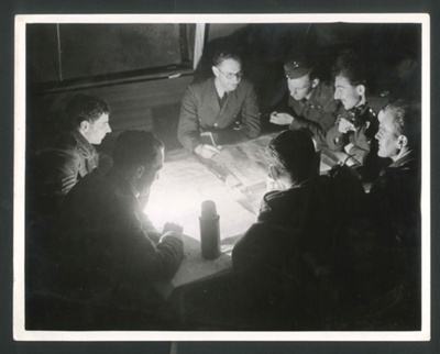 Photograph - R.A.F. Stirling bomber crew being debriefed after raid over Berlin - 23/08/1943; 23/08/1943; 2616