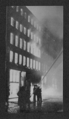 Photograph - fire hoses in action after a bombing raid in Manchester - 1940; 1/01/1940; 6812 Photograph - fire hoses in action after a bombing raid in Manchester - 1940; 1/01/1940; 6812