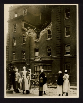 Official copyrighted war photograph- 9th September 1940- nurses viewing bomb damage to their home at a London hospital; 56550