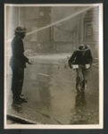 Official copyrighted war photograph- 12th September 1940- arp worked ducks under jet of water to bring firemen some hot drinks; 56543 Official copyrighted war photograph- 12th September 1940- arp worked ducks under jet of water to bring firemen some hot drinks; 56543