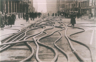 Copied official press photograph - Fire hoses in the streets on London after an air raid; 41701 Copied official press photograph - Fire hoses in the streets on London after an air raid; 41701