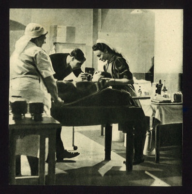 Photograph - first aid post - doctor & nurses examine a casualty; 6874