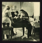 Photograph - first aid post - doctor & nurses examine a casualty; 6874 Photograph - first aid post - doctor & nurses examine a casualty; 6874