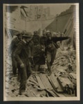 Official copyrighted war photograph- 20th October 1940- man rescued from his demolished home is carried to safety by stretcher bearers; 56554