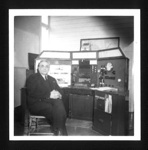 Photograph - telephone operator at desk - possibly fire service; 5565