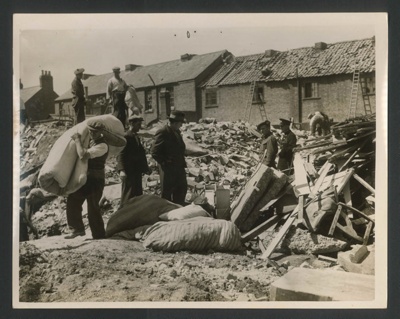Official copyrighted war photograph- 19th June 1940- bedding amongst debris of wrecked houses; 56558