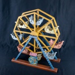 Toy Ferris Wheel made by a Prisoner of War. Stamped PW CAMP TARENT R. Found under floor boards at Romney Cottage, Barnard Castle.; 78130 Toy Ferris Wheel made by a Prisoner of War. Stamped PW CAMP TARENT R. Found under floor boards at Romney Cottage, Barnard Castle.; 78130