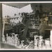Official copyrighted war photograph- 28th August 1940- workmen clearing foodstuffs from damaged shop in the north-west; 56549