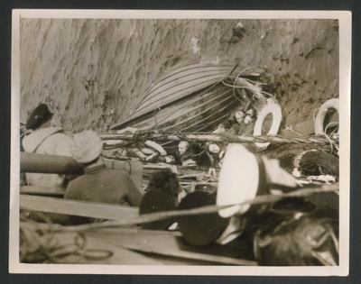 Official copyrighted war photograph - 6th May 1940 - crew of warship haul Nazi seamen aboard after their boat had overturned; 56581
