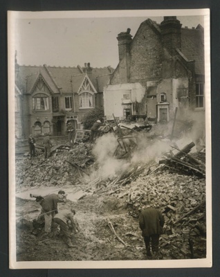 Official copyrighted war photograph- 20th September 1940- burning wreckage of bomber amongst debris in London area; 56553