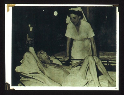 Photograph - nurse with weased P.O.W. from Japanese camp; 16684