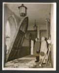 Official copyrighted war photograph- 23rd August 1940- a clergyman surveys damage to main door of church; 56559