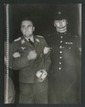 Official copyrighted war photograph - undated - Nazi airman prisoner under escort at a London station; 56576 Official copyrighted war photograph - undated - Nazi airman prisoner under escort at a London station; 56576