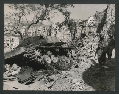 Photograph - French infantrymen pass a shattered German tank at Mount Maio - May 1944; 1/05/1944; 2614