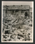 Official copyrighted war photograph- 19th June 1940- a man removes bedding from debris in East Anglia; 56562