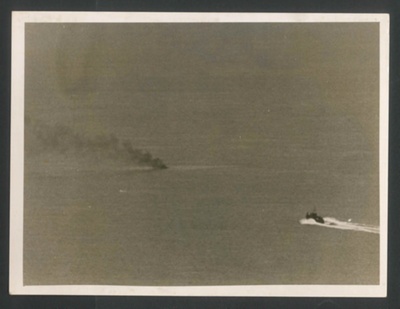 Official copyrighted war photograph - 26th August 1940 - ship racing to a burning Nazi plane off the South East coast; 56583