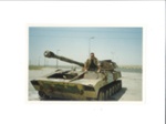 Colour photograph - L. Wainwright on damaged Iraqi tank Saudi Arabia/Kuwait border - (copy in hut 13); 35890 Colour photograph - L. Wainwright on damaged Iraqi tank Saudi Arabia/Kuwait border - (copy in hut 13); 35890