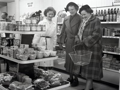 fht.2026.96  mustard's the grocer, at no 81 high street, became the first self service shop in town in 1955, pictured here with assistant wendy mackenzie helping shoppers.