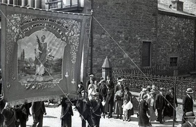 fht.2026.92  last public parade of the loyal st lawrence lodge  banner in 1939, passing the town hall and high church. note the railings which were sold later for the war effort.