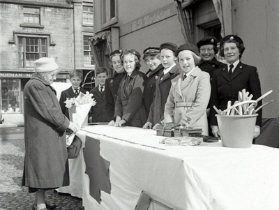 fht.2026.105  red cross mile of pennies outside bessie hodsdon's shop at 78 high street, 18th may 1963. in the background is norman mackenzie's at 73, and the lido cafe at 71-69 high street