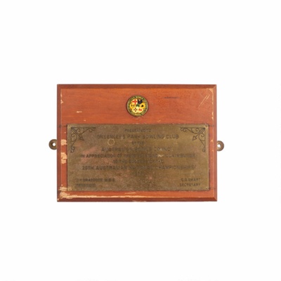 Brass Plaque on wooden shield: Presented to the Greenlees Bowling Club by the Australian Bowls Council. In appreciation of their outstanding contribution to the success of the 29th Australian National Championship, 1975; 1975; OB0119 Brass Plaque on wooden shield: Presented to the Greenlees Bowling Club by the Australian Bowls Council. In appreciation of their outstanding contribution to the success of the 29th Australian National Championship, 1975; 1975; OB0119