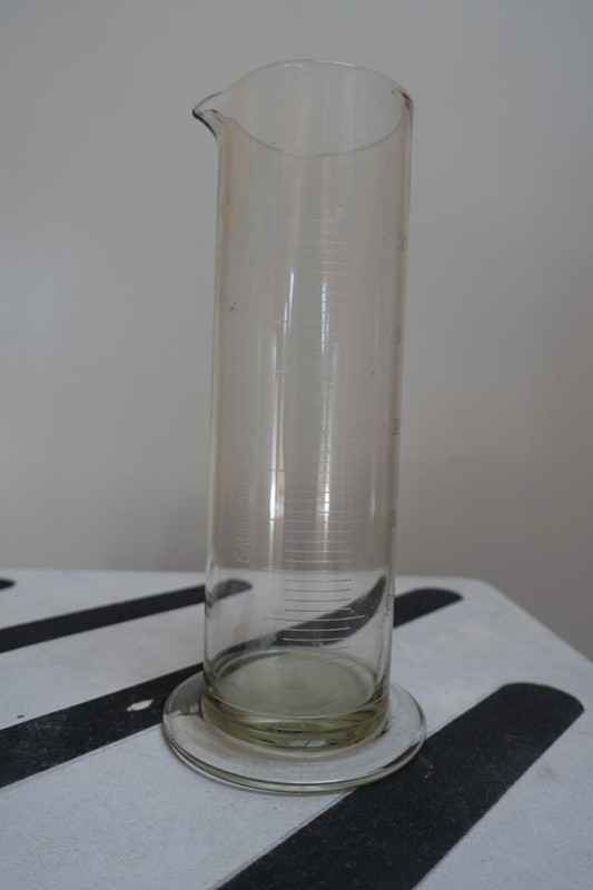 Rain gauge (graduated beaker) used by Deny King at Melaleuca and marked