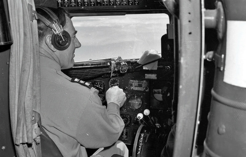 Aviation, Co-Pilot or First Officer in the interior of the Cockpit, at the Controls of a two engine aircraft ( see number of throttles ) Possibly a Douglas DC3. Canterbury, New Zealand.
