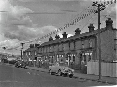 Building. Blackheath Place, Built by Bricklayer Frank Hathaway Hitchings for Himself and his Extending Family. The only Buildings in This English Style of Terrace Housing in Christchurch. No One Wanted More The Sydenham Borough Council wanted no more. They came to New Zealand to Get Away from This. The Front car is a c1955 Morris Oxford. 63 - 81 Durham Street, Christchurch, Canterbury, New Zealand. image item
