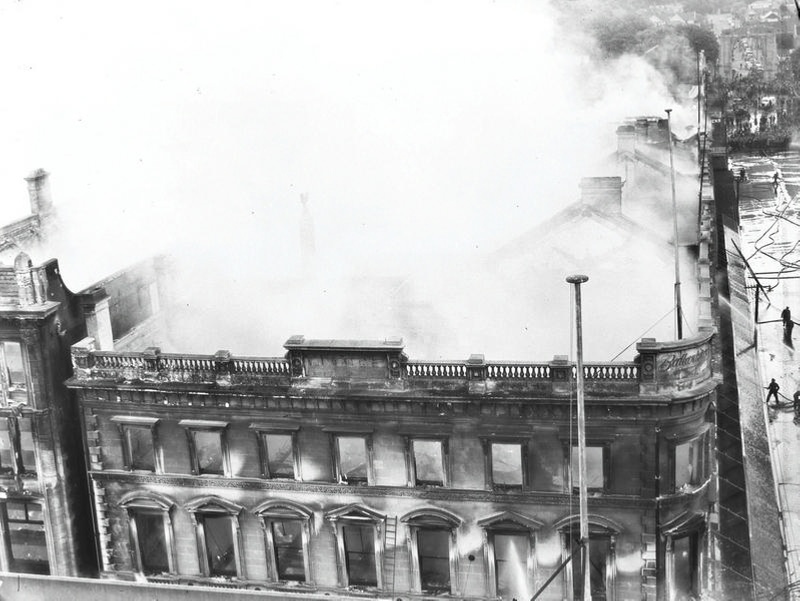 Ballantyne's Fire, Colombo Street Frontage with Cashel Street on the right with Firemen and the Bridge of Remembrance in the distance. Christchurch, Canterbury, New Zealand.