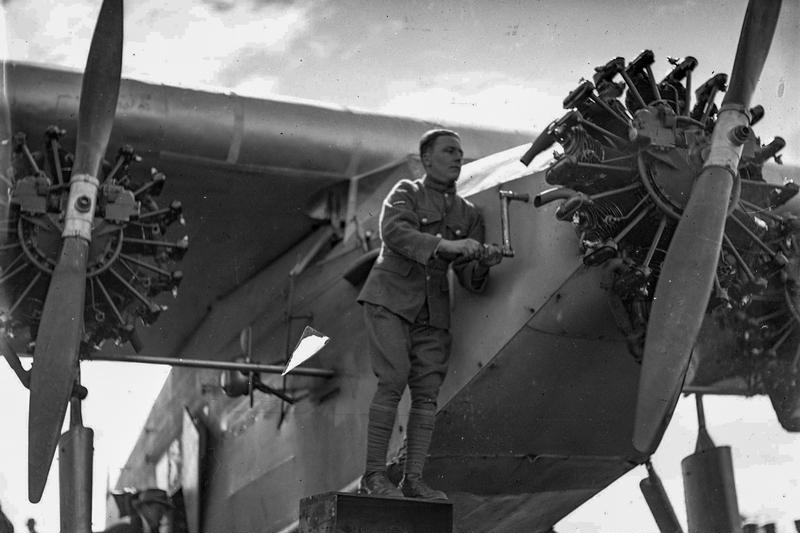 Aviation, Southern Cross, Fokker F.VII/3m. No Registration Mark on Side. Winding it Up. Three Engines. Two Bladed Propellors. Piloted by Squadron Leader Charles Kingsford Smith. Accompanied by Co-Pilot Charles Ulm, Navigator Harold Arthur Litchfield, and Radio Operator Thomas H. McWilliams, a New Zealander made available by the New Zealand Government. 11 September 1928. After a 14.5 Hour Flight From Richmond, Near Sydney, NSW, Australia. The First Flight into New Zealand, They Came Across the Tasman Sea. Wigram Airfield, Christchurch, Canterbury, New Zealand. (7)