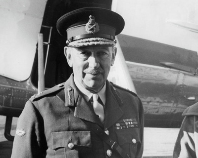 Army. This soldier is a Lieutenant-General, Indicated by the Crown and Crossed Sword and Scabbard on his Lapel and the red Flashes on His Lapels. The WWI Tank on his Right Sleeve Indicates his Involvement in the Armoured Corps. He is Standing in Front of an Unidentified Aircraft. New Zealand. A Governor General?? image item