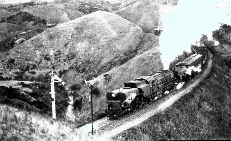 Railway. Bayer-Peacock Garrett G Class 4-6-2+2-6-4 Steam Locomotive Passing a Semaphore Signal with a Passenger Carriage on the Johnsonville Line. Wellington. New Zealand