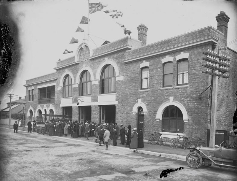 Fire. Christchurch Fire Station, Crowd. One Appliance Partly Visible. Note the Common Use of the British Union Jack. Lichfield Street. Christchurch, Canterbury, New Zealand.