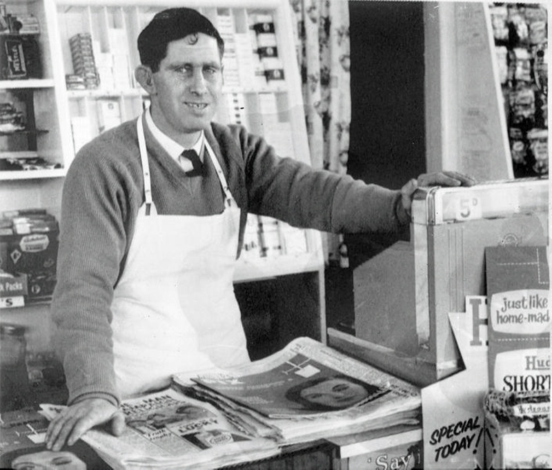 Corner Dairy. Shop Selling Newspapers, Magazines, Cigarettes ( In Packets  Behin