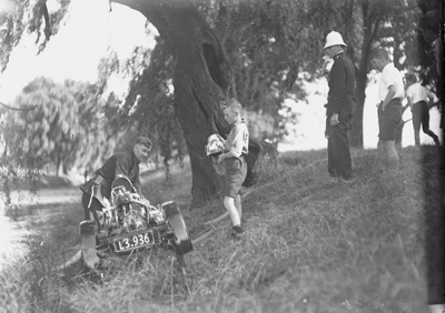 Fire. Fire Brigade Training with Light Trailer Pump. Police and Boys Present Brass Helmet Days. Avon River. Christchurch, Canterbury, New Zealand. 2 image item