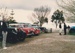 A line up of vintage cars parked at the entrace to Howick Historical Village on a Live Day.; Ashby, Muriel; P2021.108.25