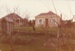 Looking over a garden to the cottages on Grey Street, Howick Historical Village; La Roche, Alan; December 1982; P2020.124.03