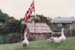 Geese on the grass in front of the Union Jack flying outside the mail runner's cottage on its opening day, in Howick Historical Village.; La Roche, Alan; 1 November 1992; P20210.83.22