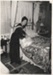 Eileen Martensen making a bed at the 1962 exhibition of the Howick Historical Society in the Howick Town Hall.; N.Z.Herald; 1962; P2022.10.13